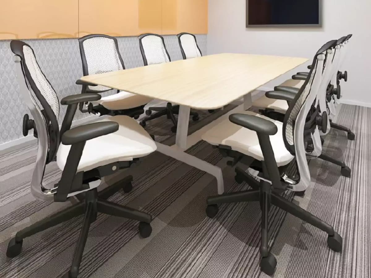 small meeting room with work desk and rolling chairs