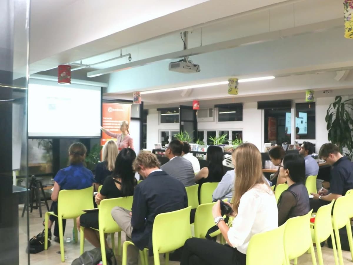 people are attending corporate seminar in theatre style seating