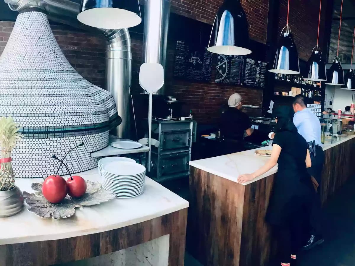philippines restaurant with wooden kitchen bar and black pendant lamps