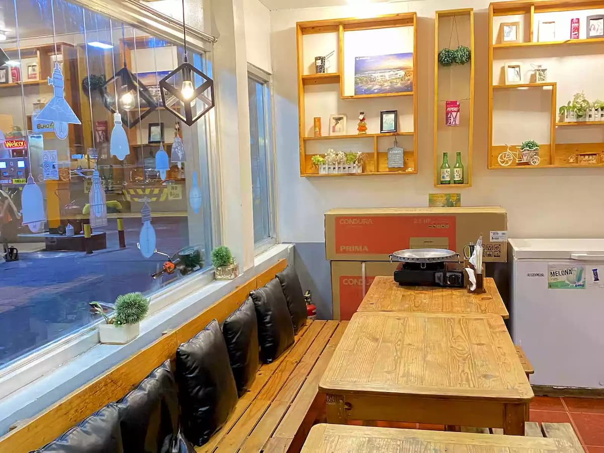 restaurant with hanging lights and large window valenzuela