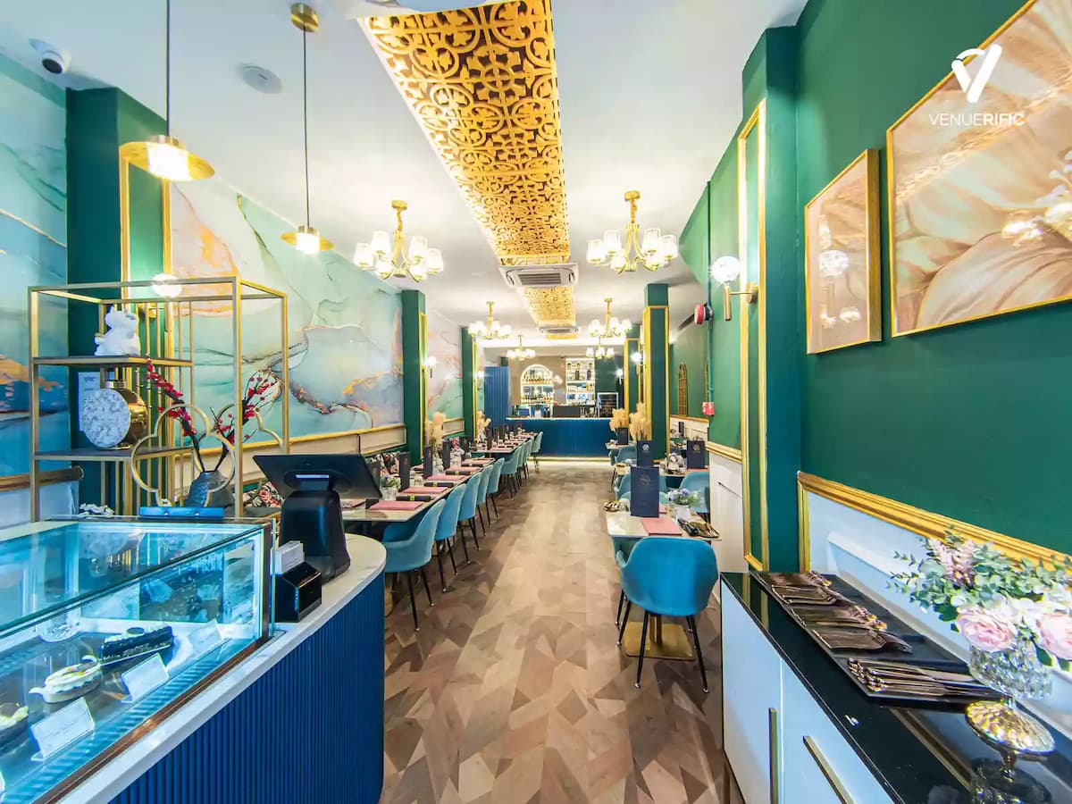 restaurant with pastry display, long tables and blue chairs