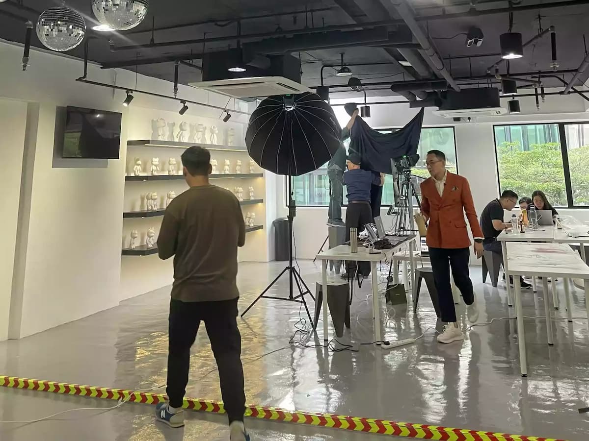 men fixing photoshoot area of art space