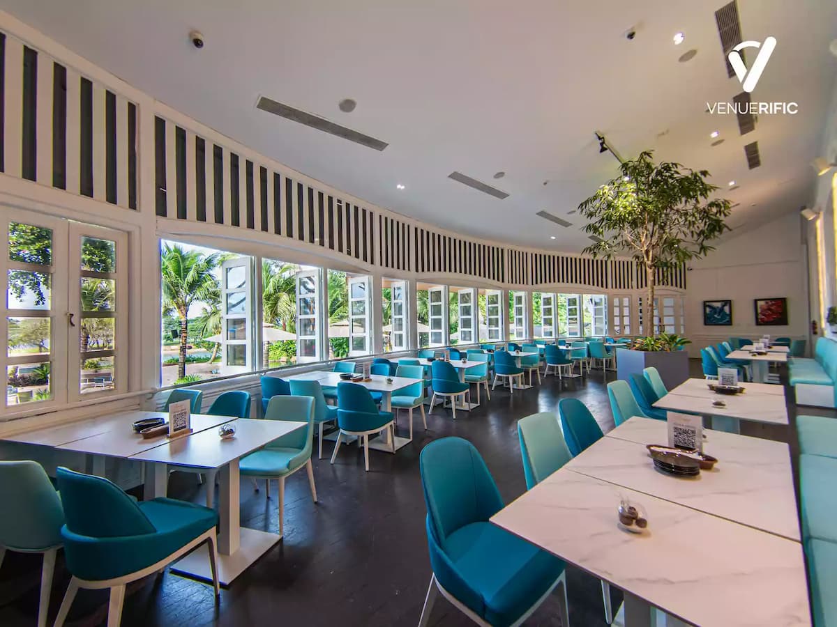 spacious restaurant dining area with sea color chairs 