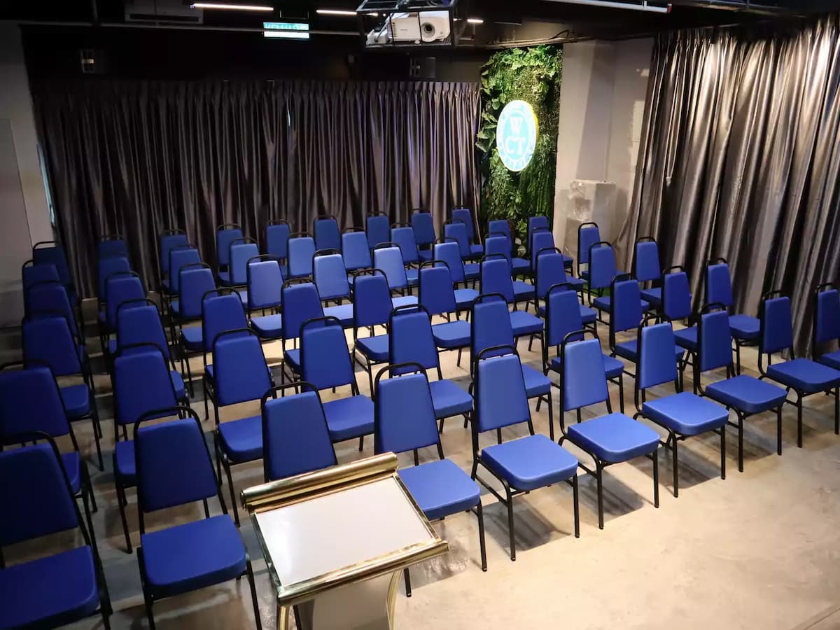 rows of chairs in medium room facing front
