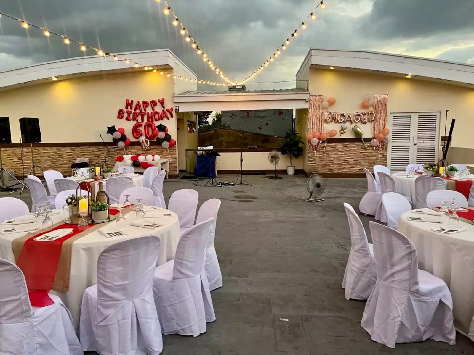 round set tables with "Happy Birthday 60" balloons in front
