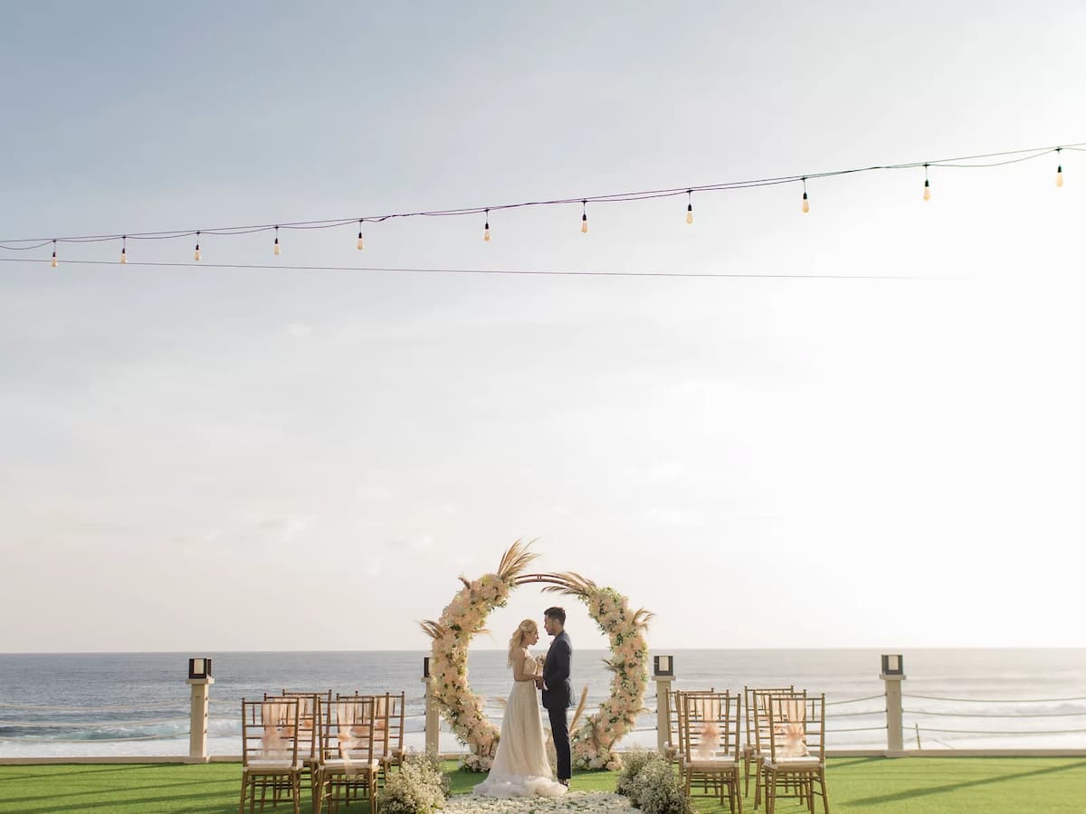 a couple wedding in front of a beach