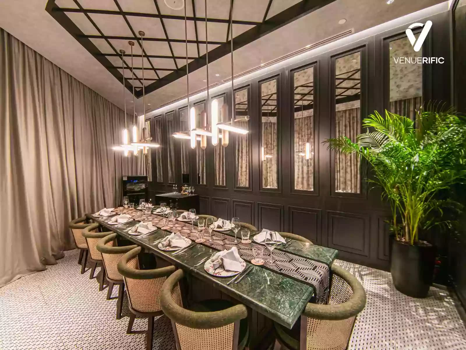 a private room with elegant ceiling and long table