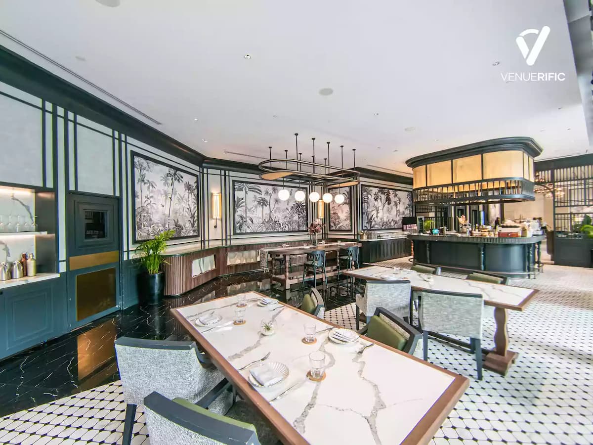 a lounge are with bar and long tables