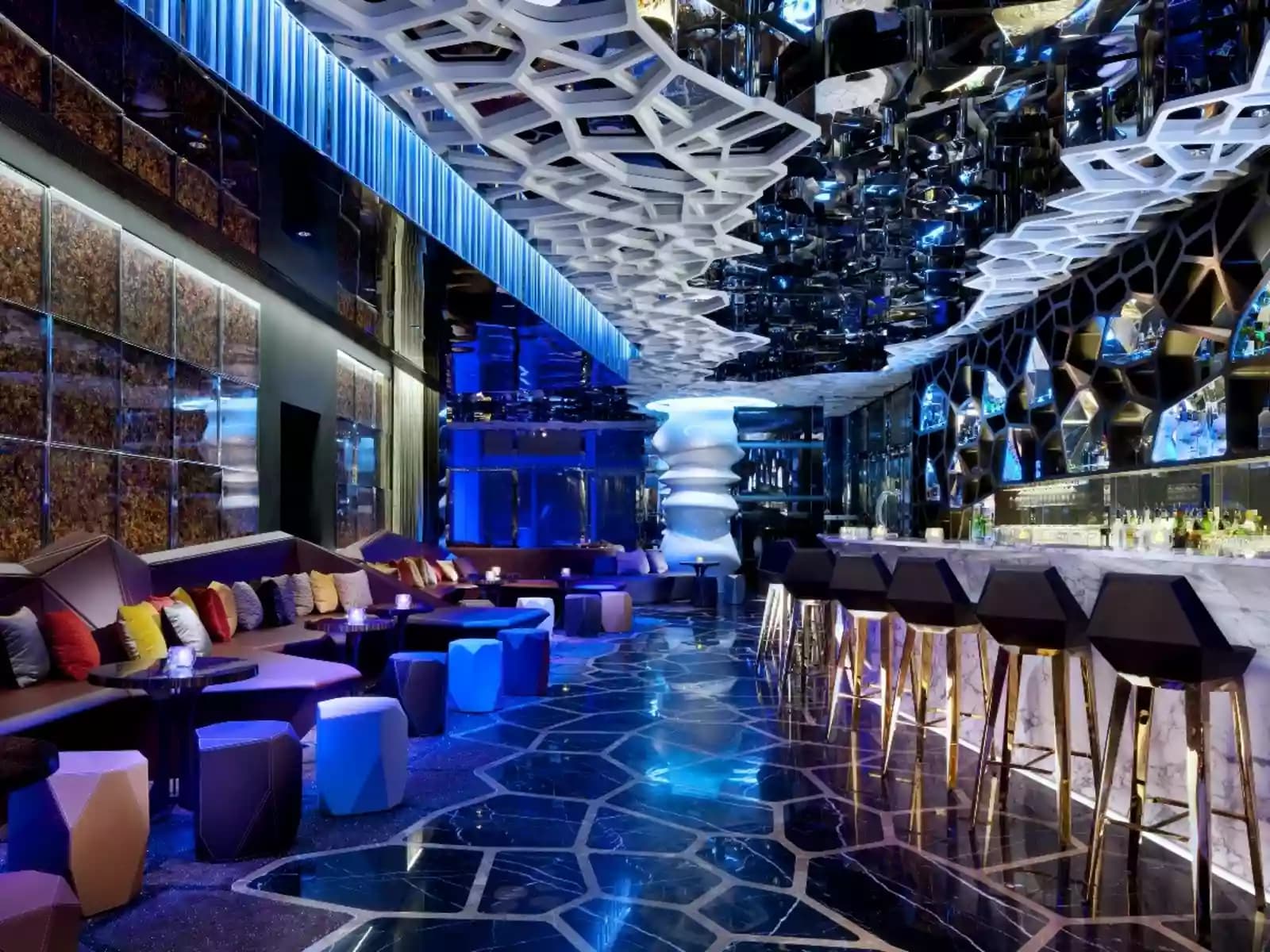 bar, high chairs and lounge area in futuristic space