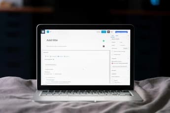 open wordpress editor on laptop screen with seo plugin and blog draft fields visible on a bed