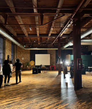 group preparing event in open loft with wooden beams brick walls and industrial lighting