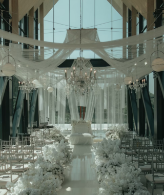 indoor chapel wedding venue with white aisle floral decorations and chandelier lighting Set 2