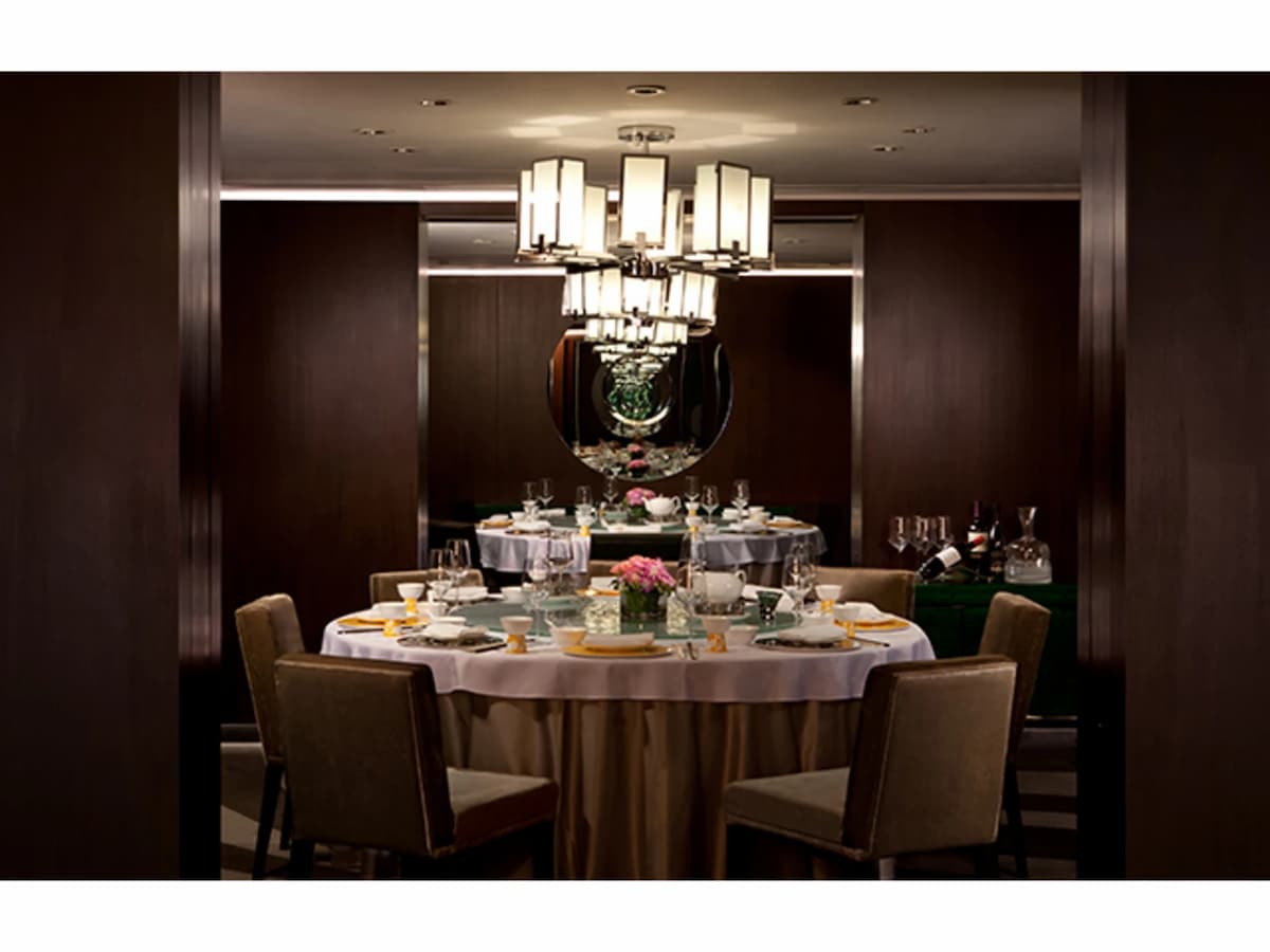 private dining room using round table and chandelier