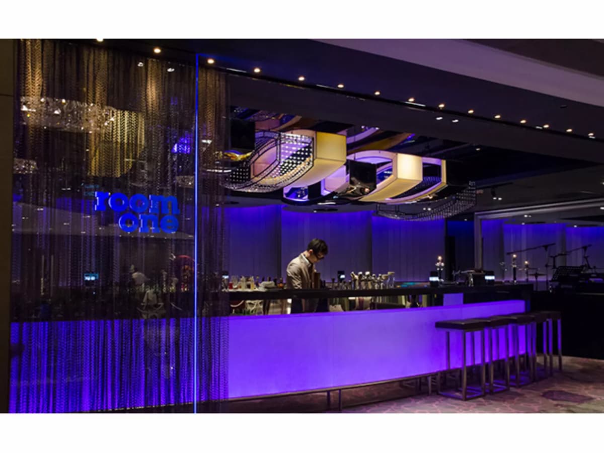 bartender preparing drinks behind bar