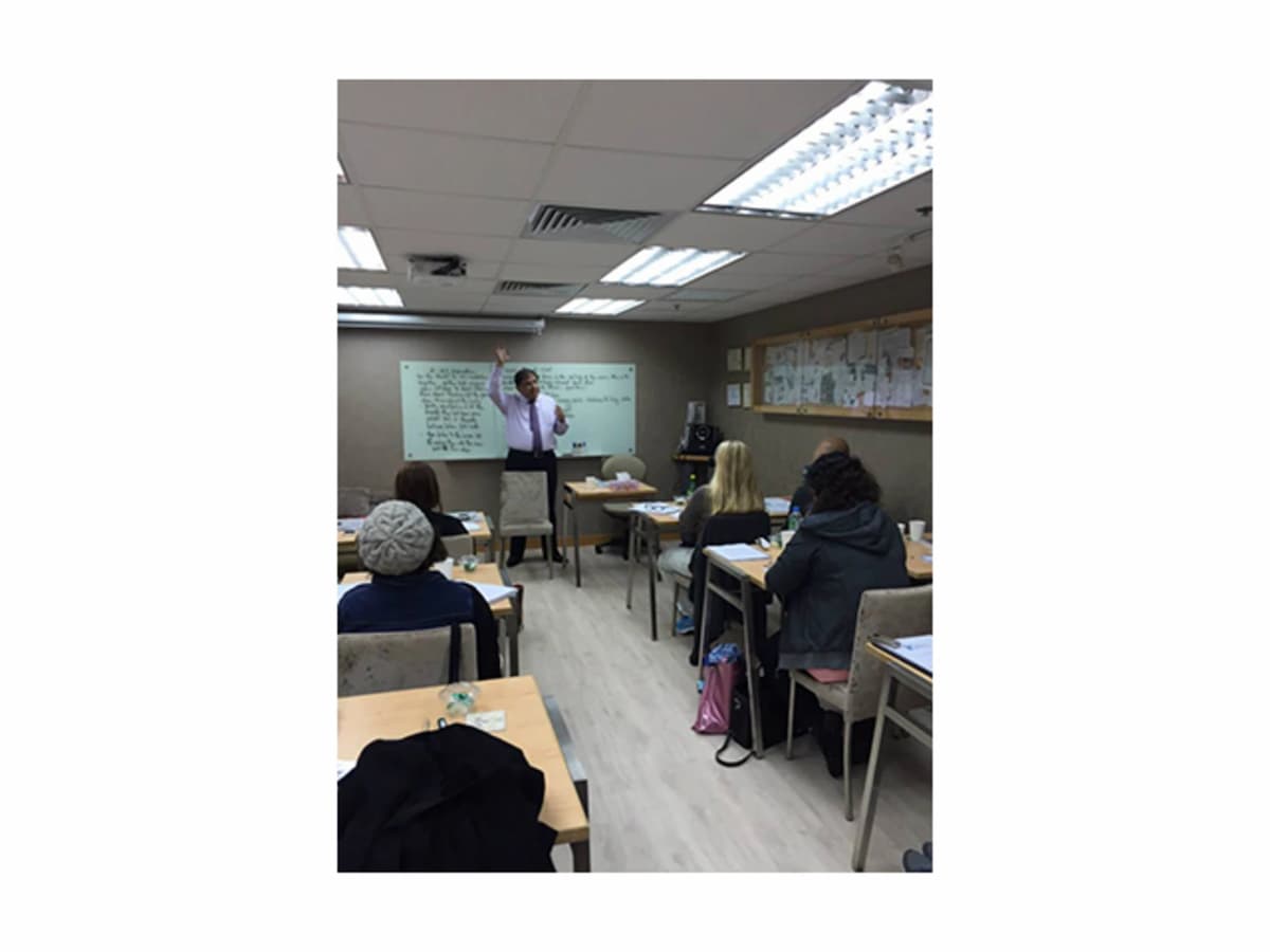 training session using classroom setup with whiteboard and projector