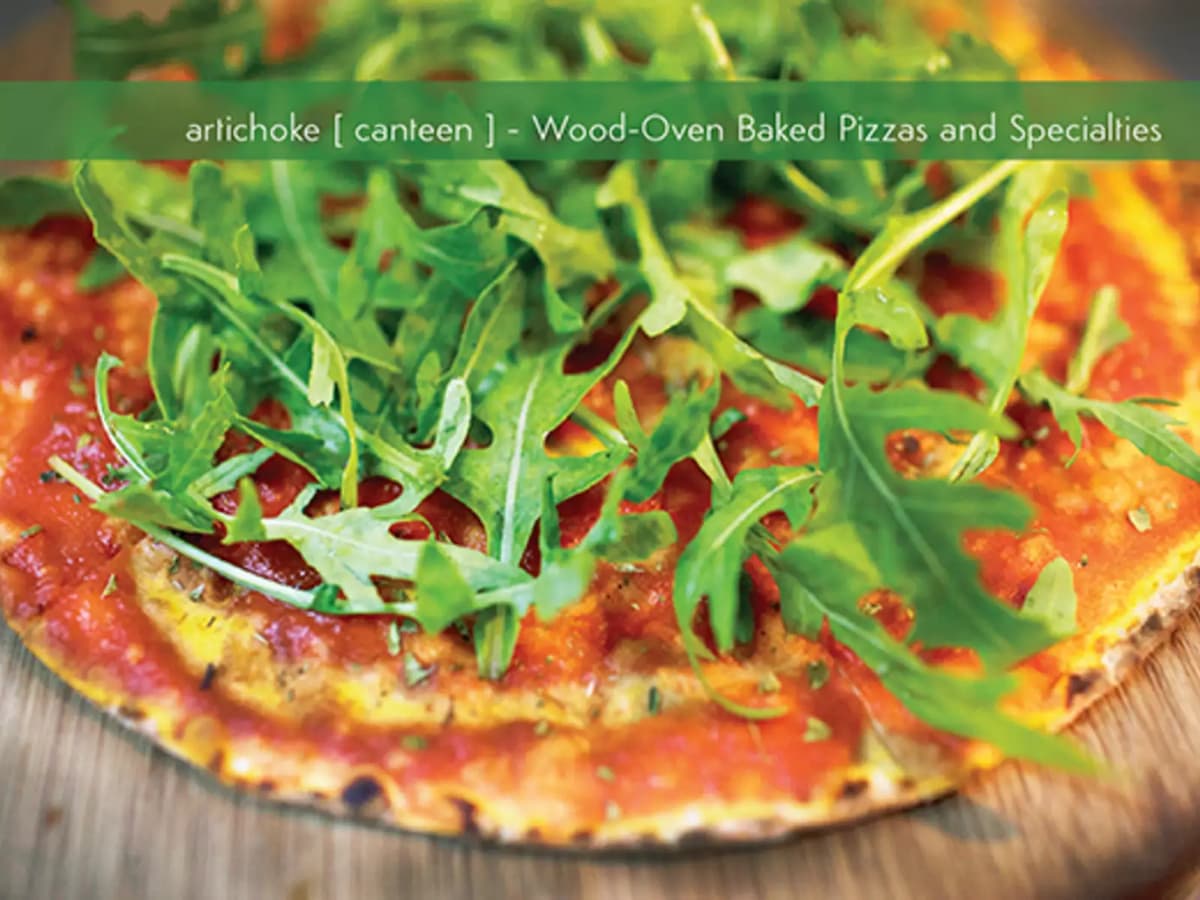 wood-oven baked pizza with vegetables served on the table