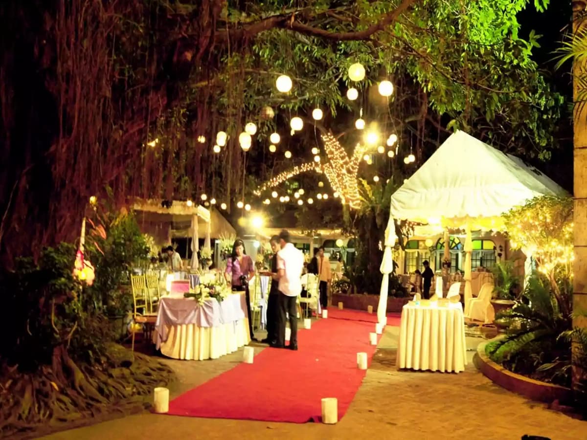 outdoor wedding aisle in between table and buffet station tent