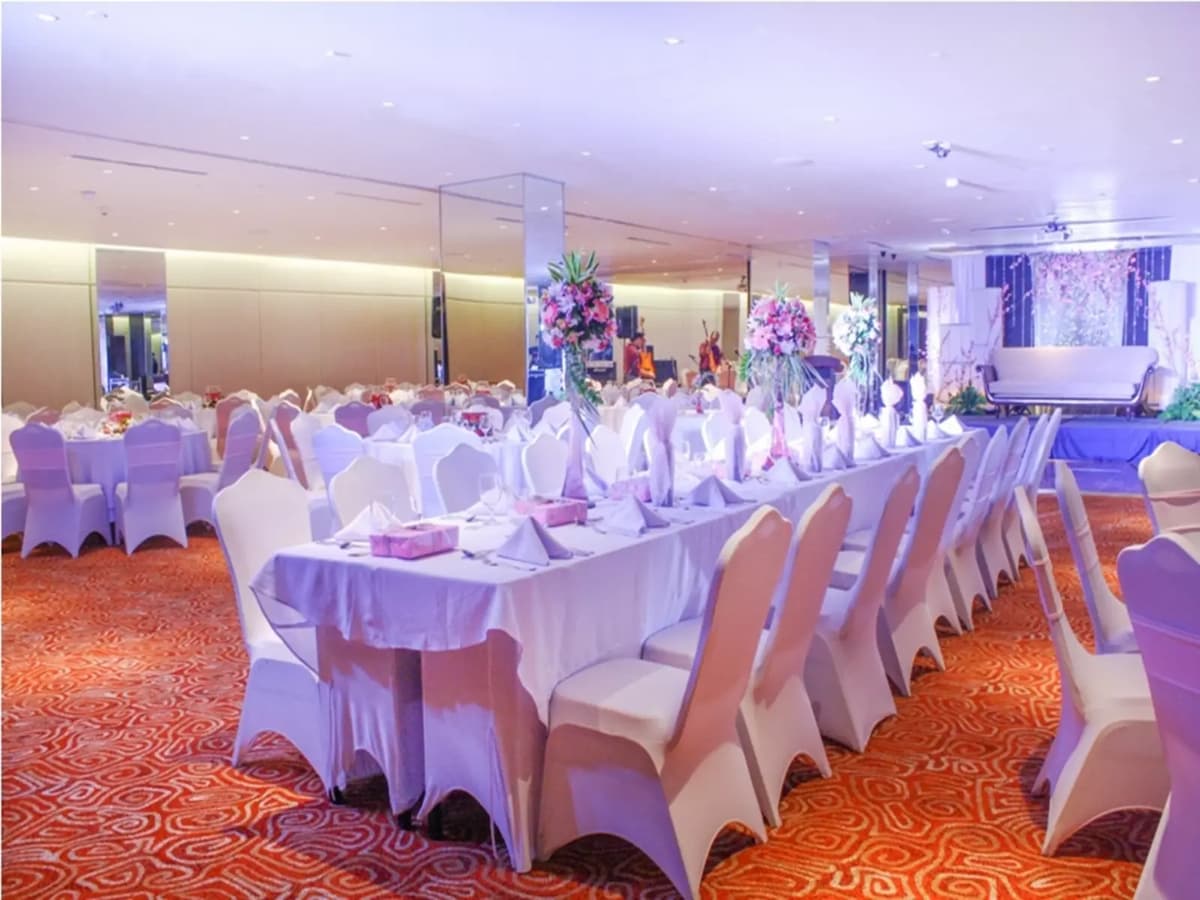 philippines indoor year-end party space with white long dining table and flower decorations