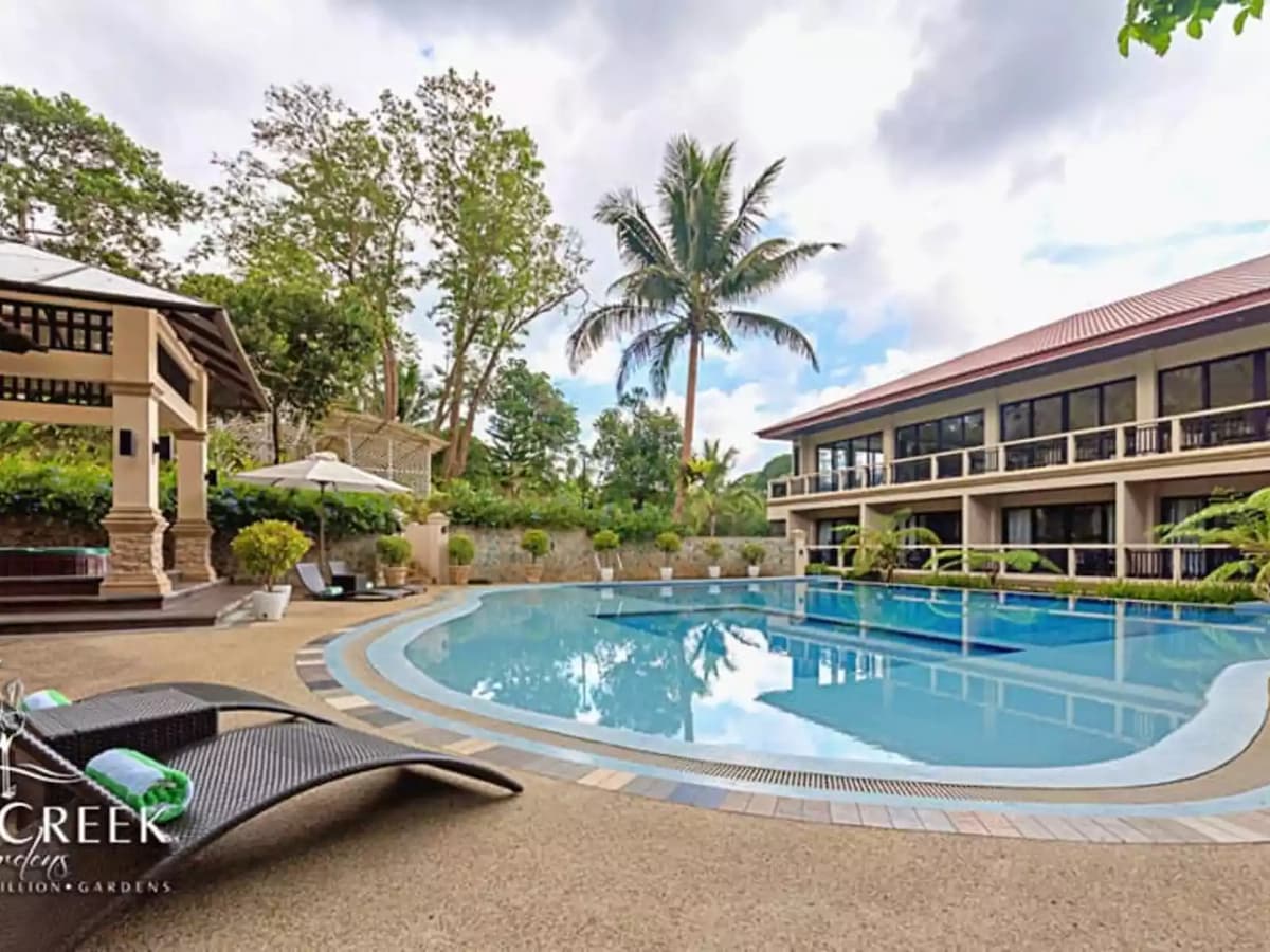 outdoor swimming pool surrounded with nature and function hall building tagaytay