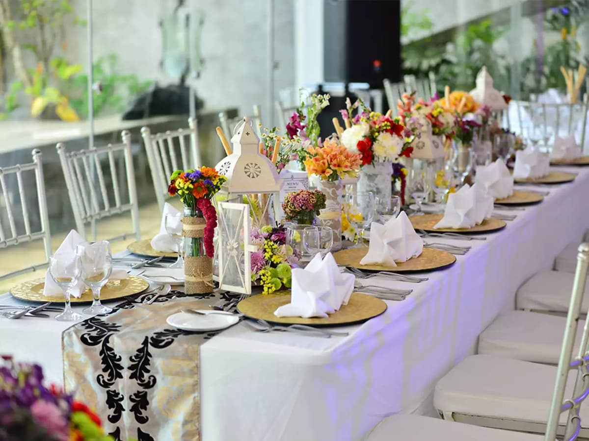 birthday party space in tagaytay with long white
table and flower decorations