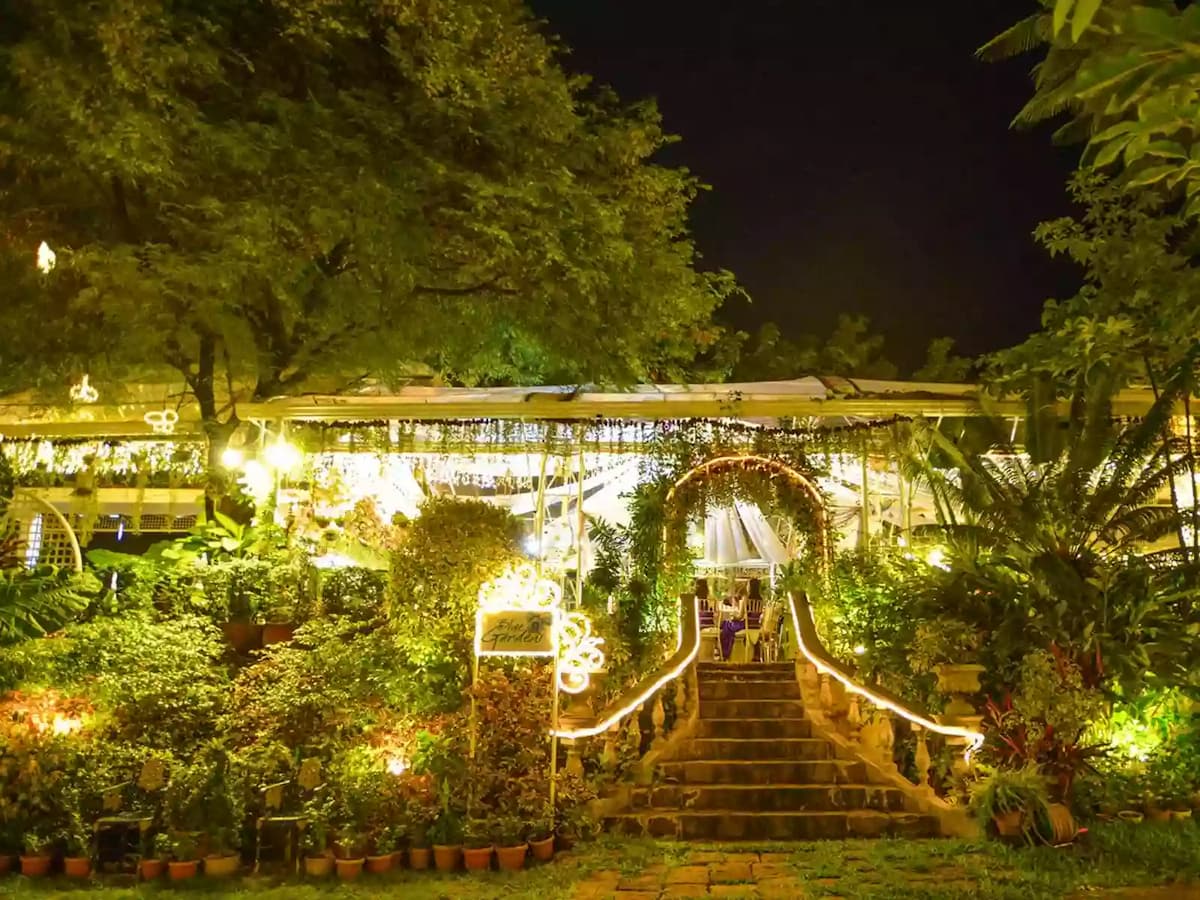 the entrance of blue gardens surrounded with trees and green environment quezon city