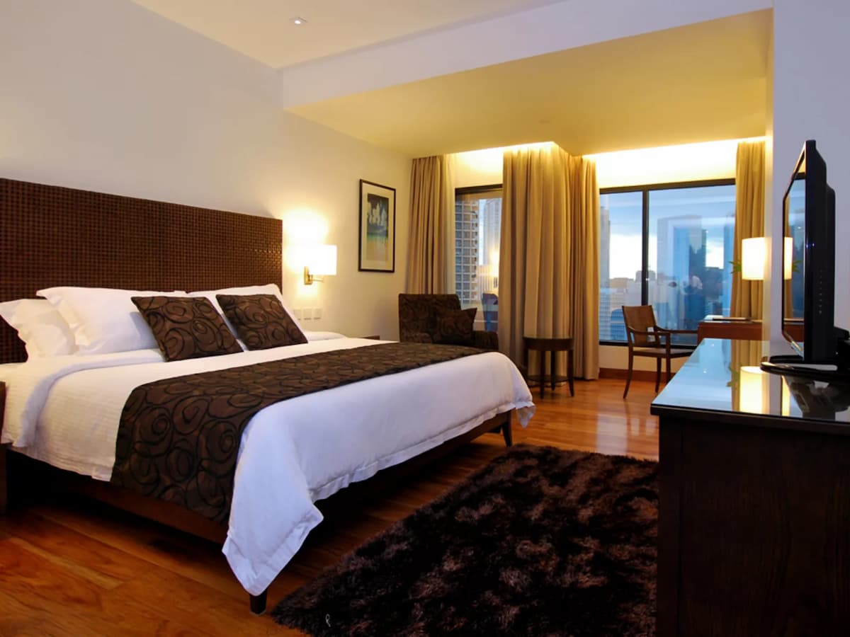 hotel bedroom with the panoramic view of the city