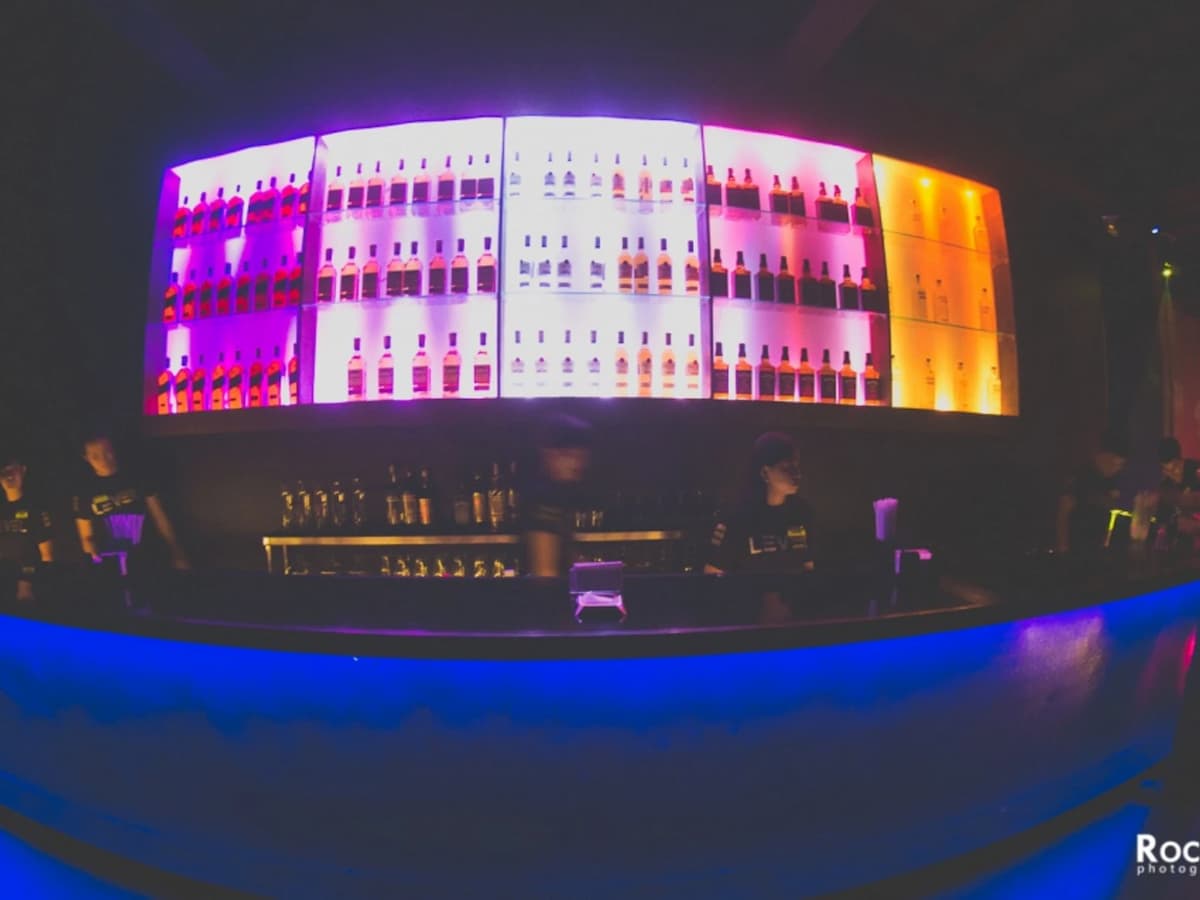 bartenders behind bar; alcohol rack quezon city