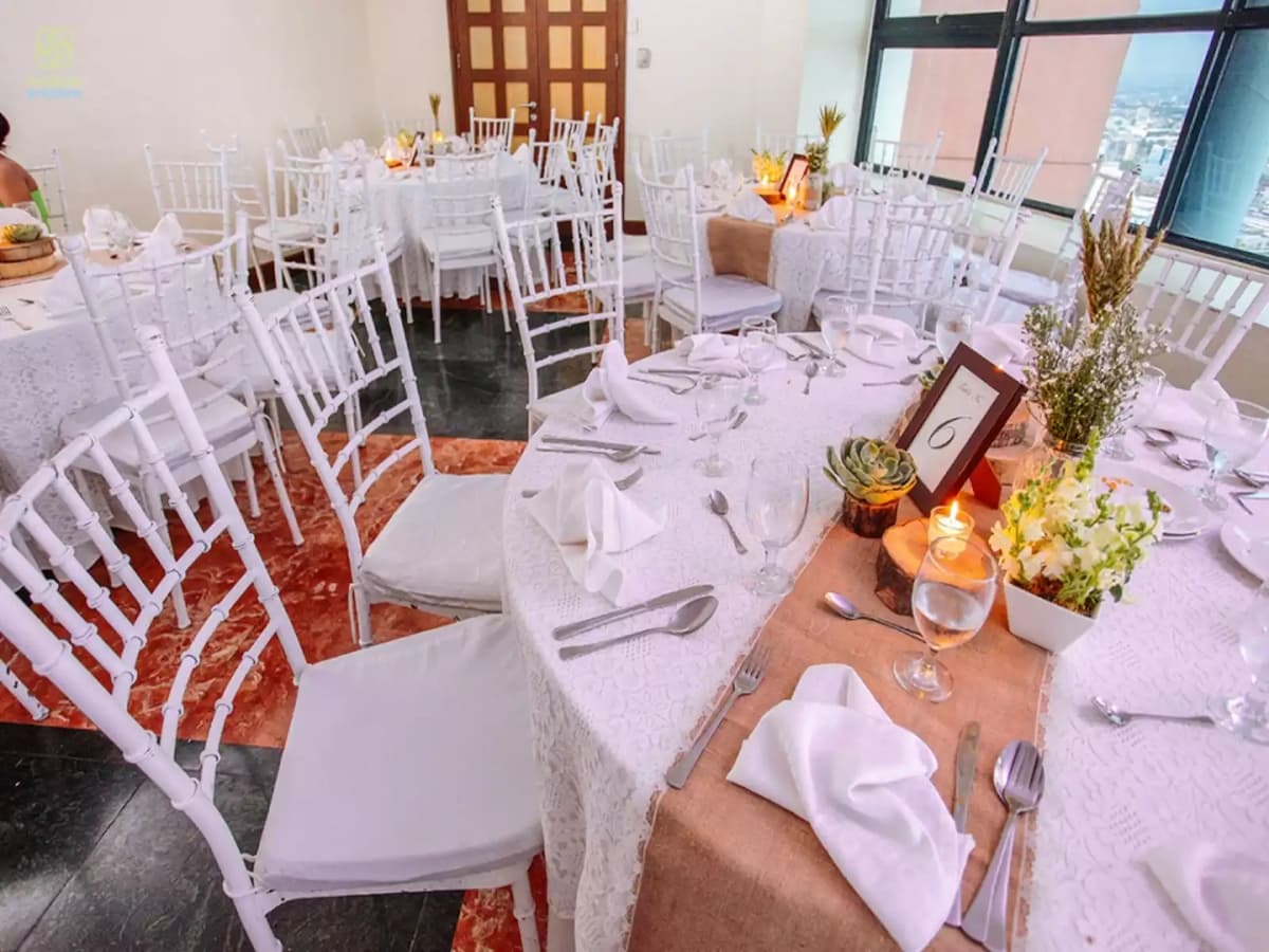 manila party venue with white banquet seating and big windows