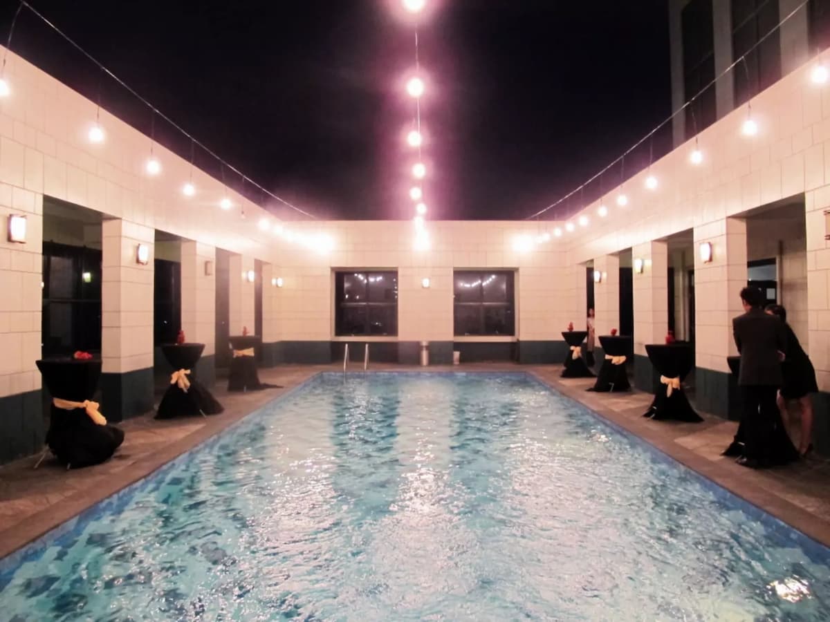 indoor event space in manila with large pool and several cocktail tables