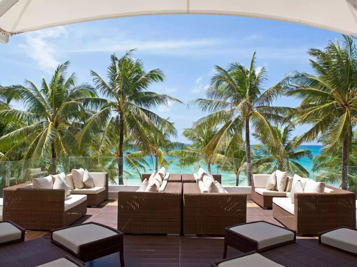 lounge chair overlooking beach area; coconut trees boracay hotel