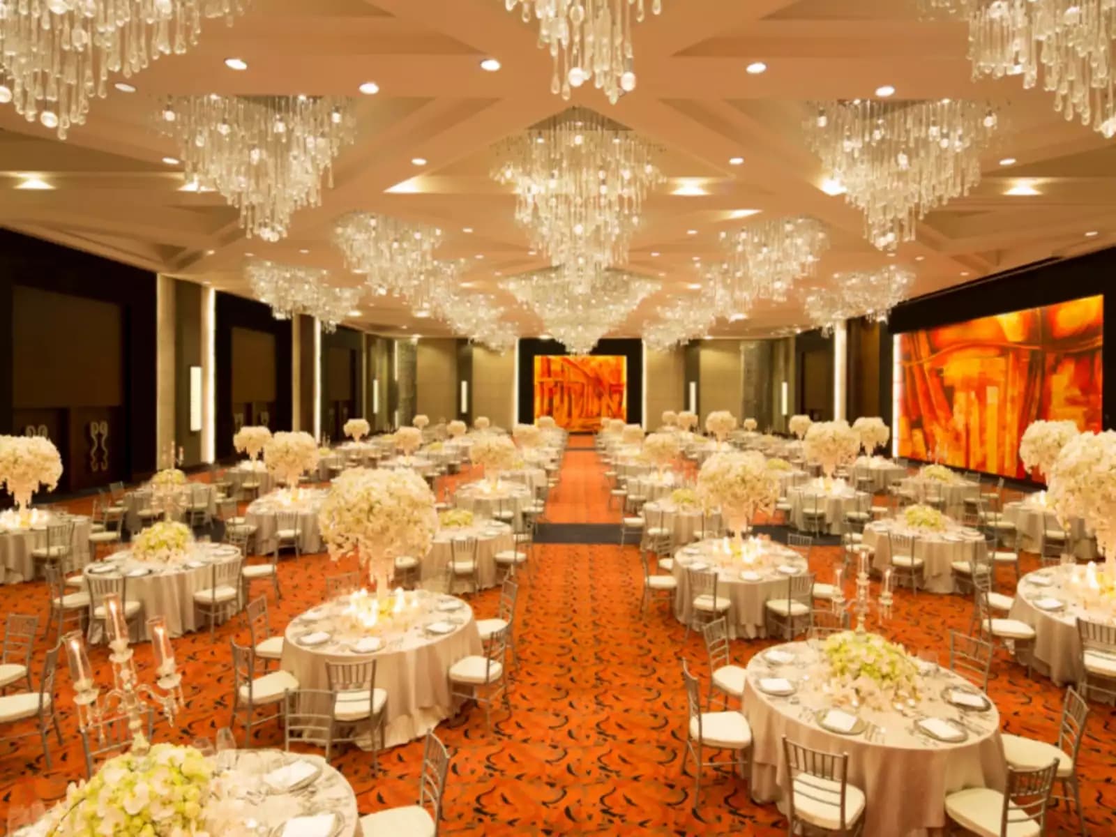table setup adn crystal chandelier in hotel ballroom