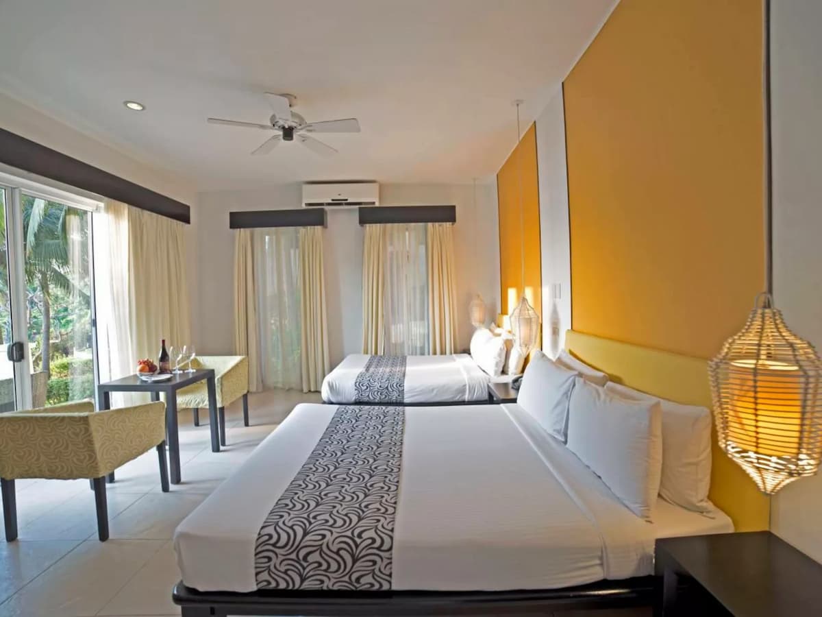 bedroom with 2 king bed and floor to ceiling window hotel batangas