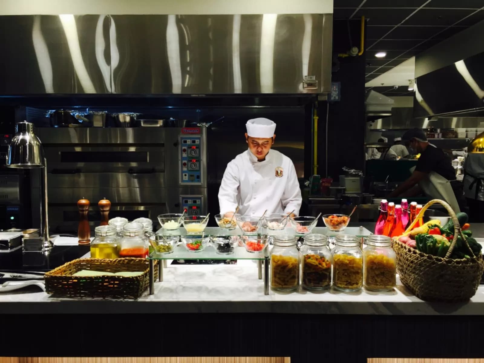 philippines restaurant's chef with white apron standing behind the buffet restaurant paranaque