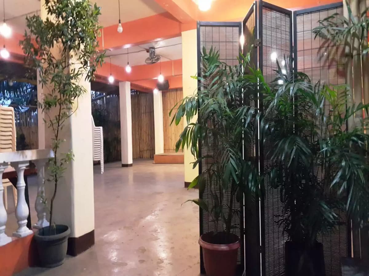 high ceiling party space in navotas with room divider and plants around event space manila