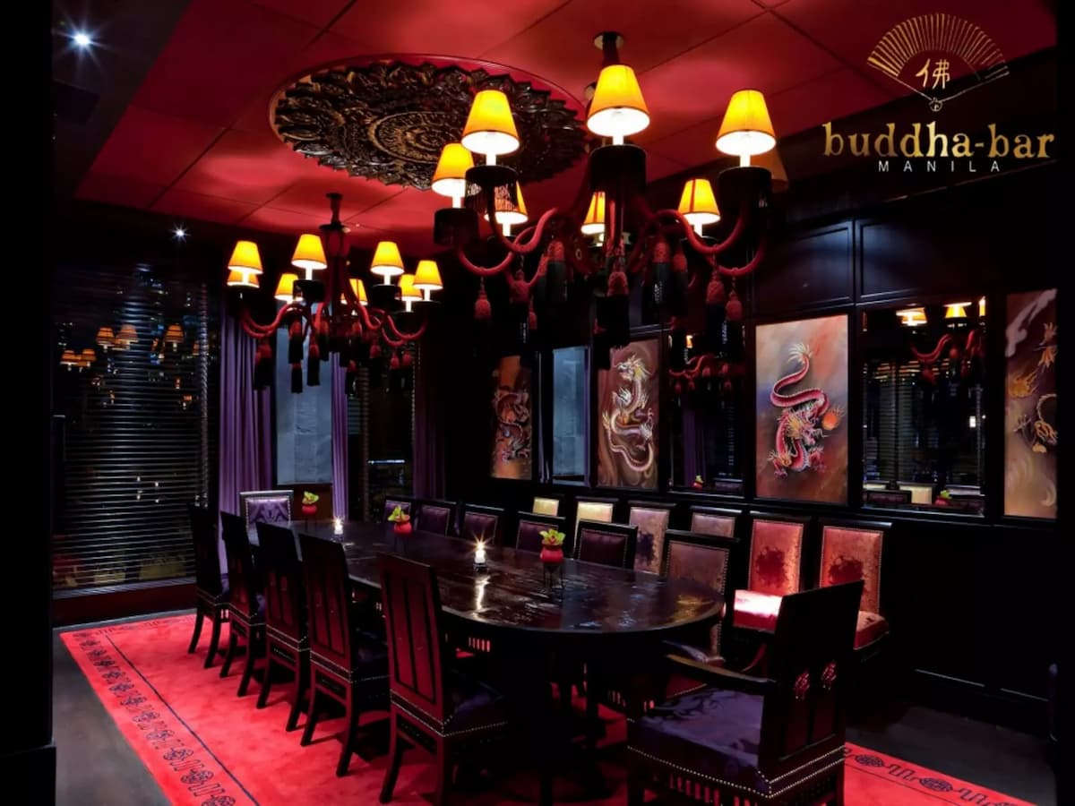 private dining room with red dominated interior and dragon paintings on the wall makati bar