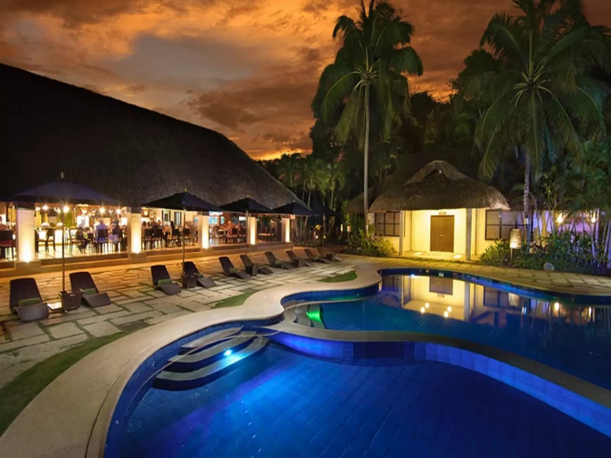 swimming pool; lounge chairs by the deck hotel bohol