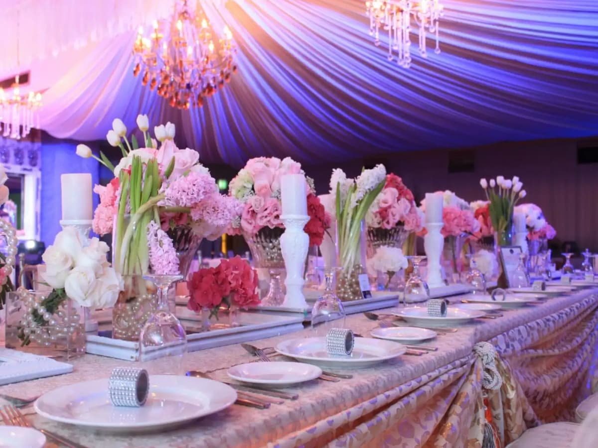 philippines 50th birthday party venue decorated with pink flowers and crystal pendant lamps