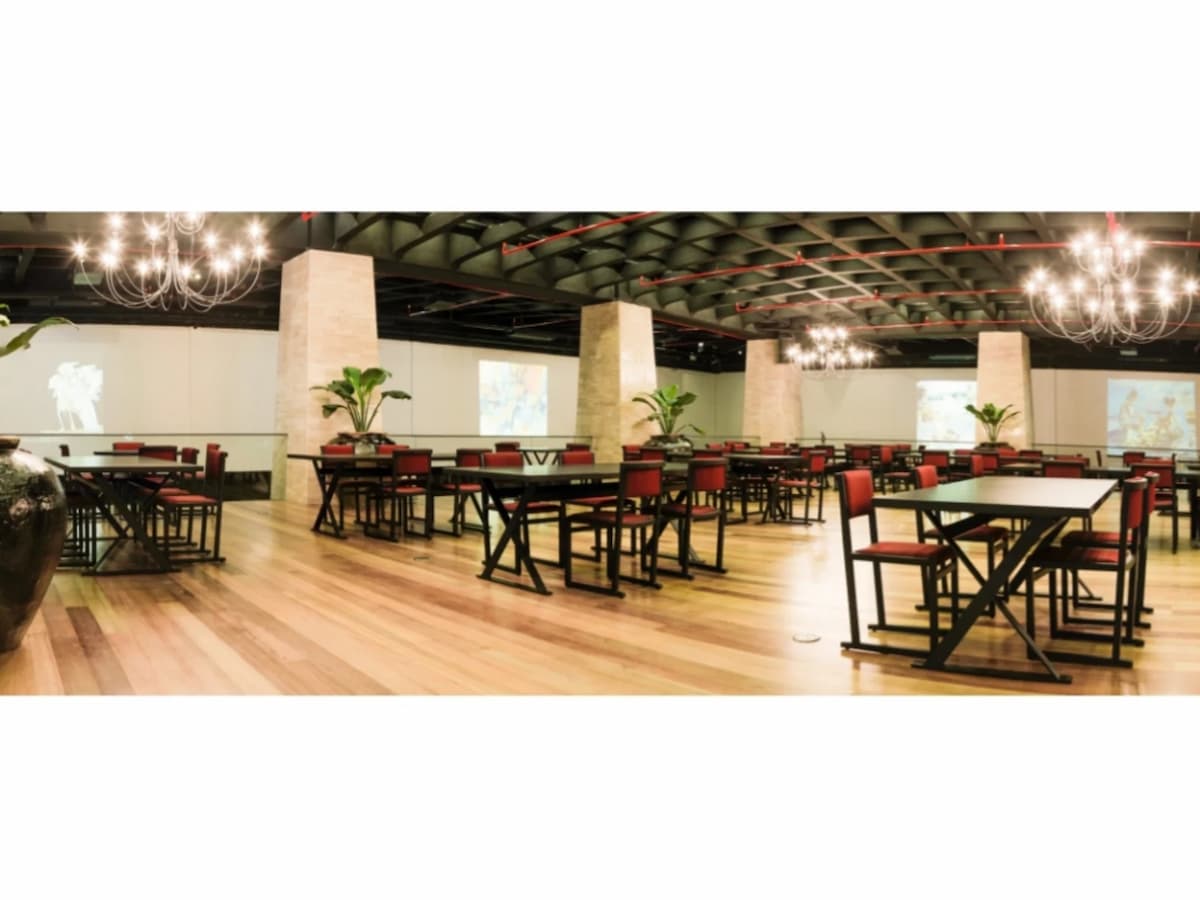 event space with gleaming chandeliers and wooden floor