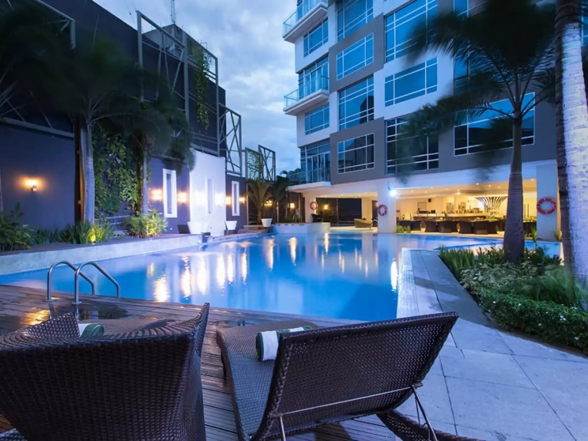 outdoor swimming pool with hotel building's view hotel general santos city