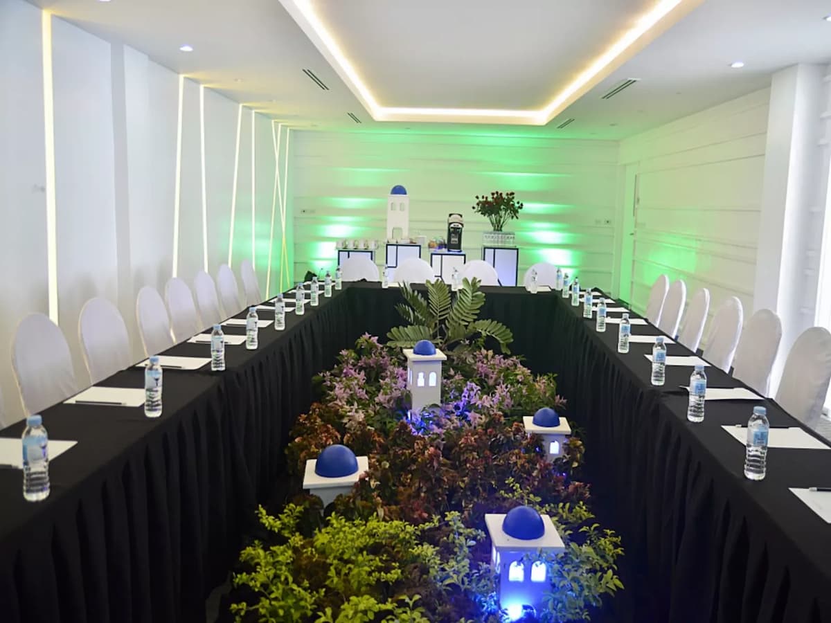 private meeting room with white interior and long black table hotel la union