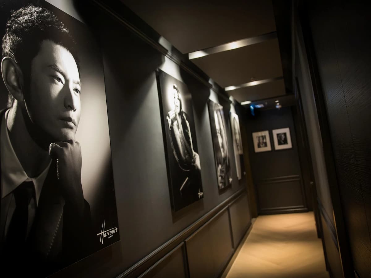 hallway in studio harcourt with lot of photos hanging on the wall