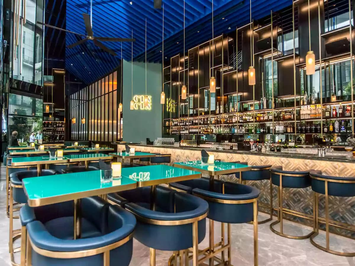 gin bar decked out with chic padded stools and couch