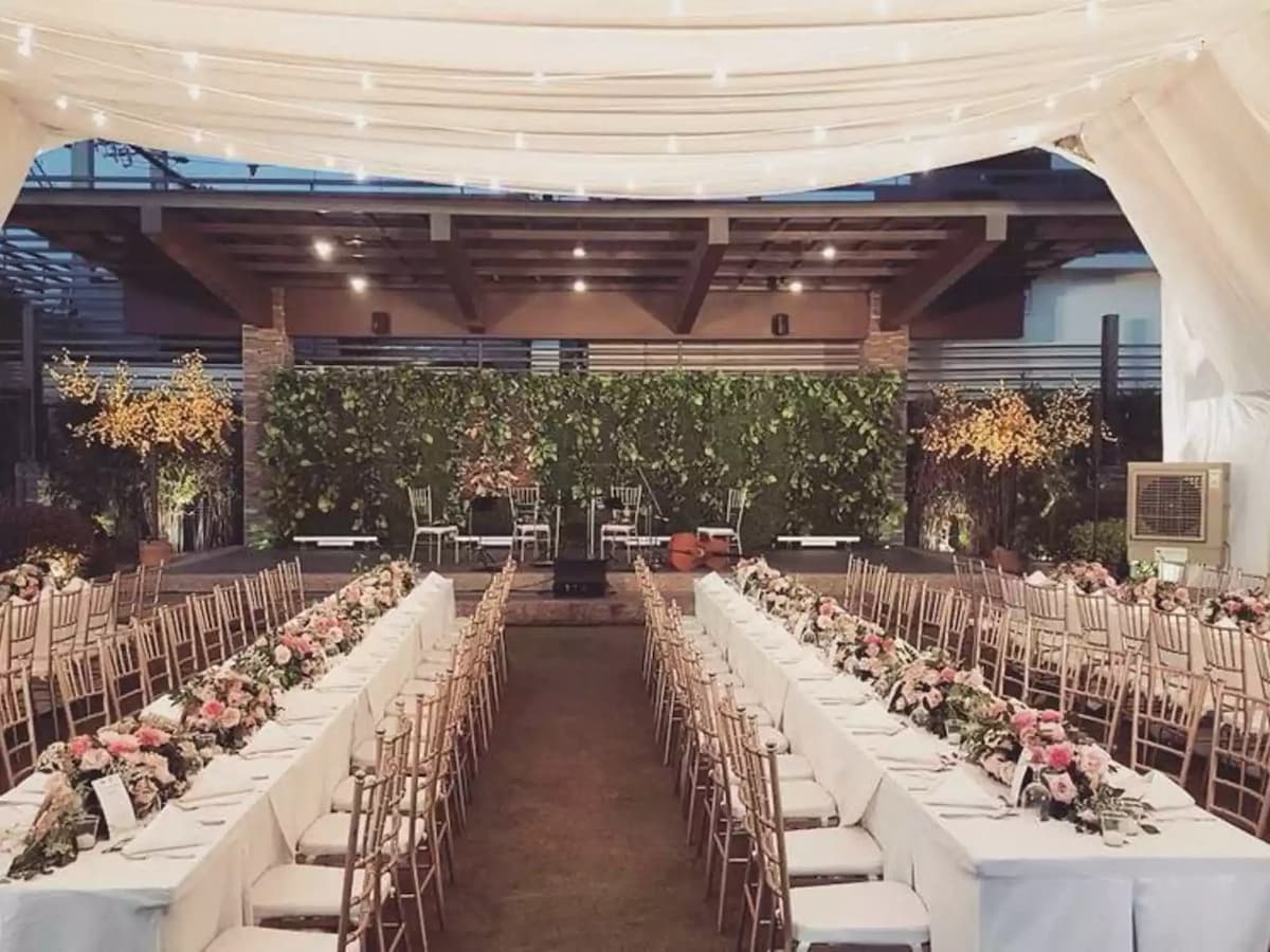 rows of dining tables decorated with flowers; centre stage cebu
