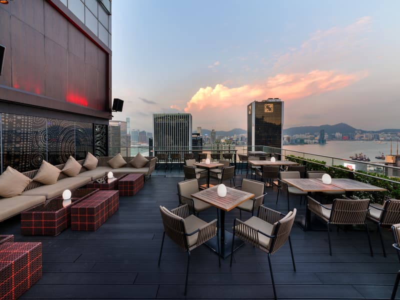 rooftop bar area with sofa table and table chair setting