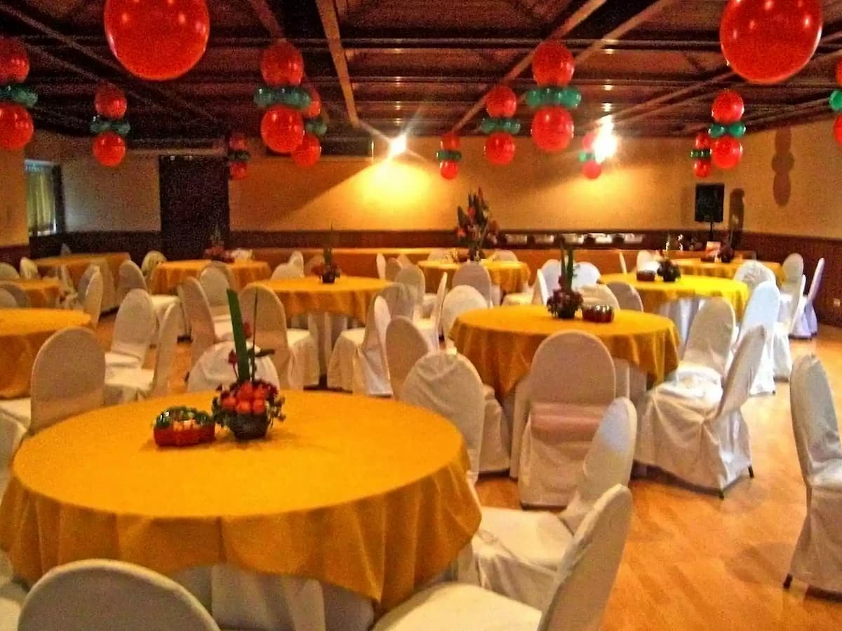 large event venue with round table set up covered with golden cloth country club pasig
