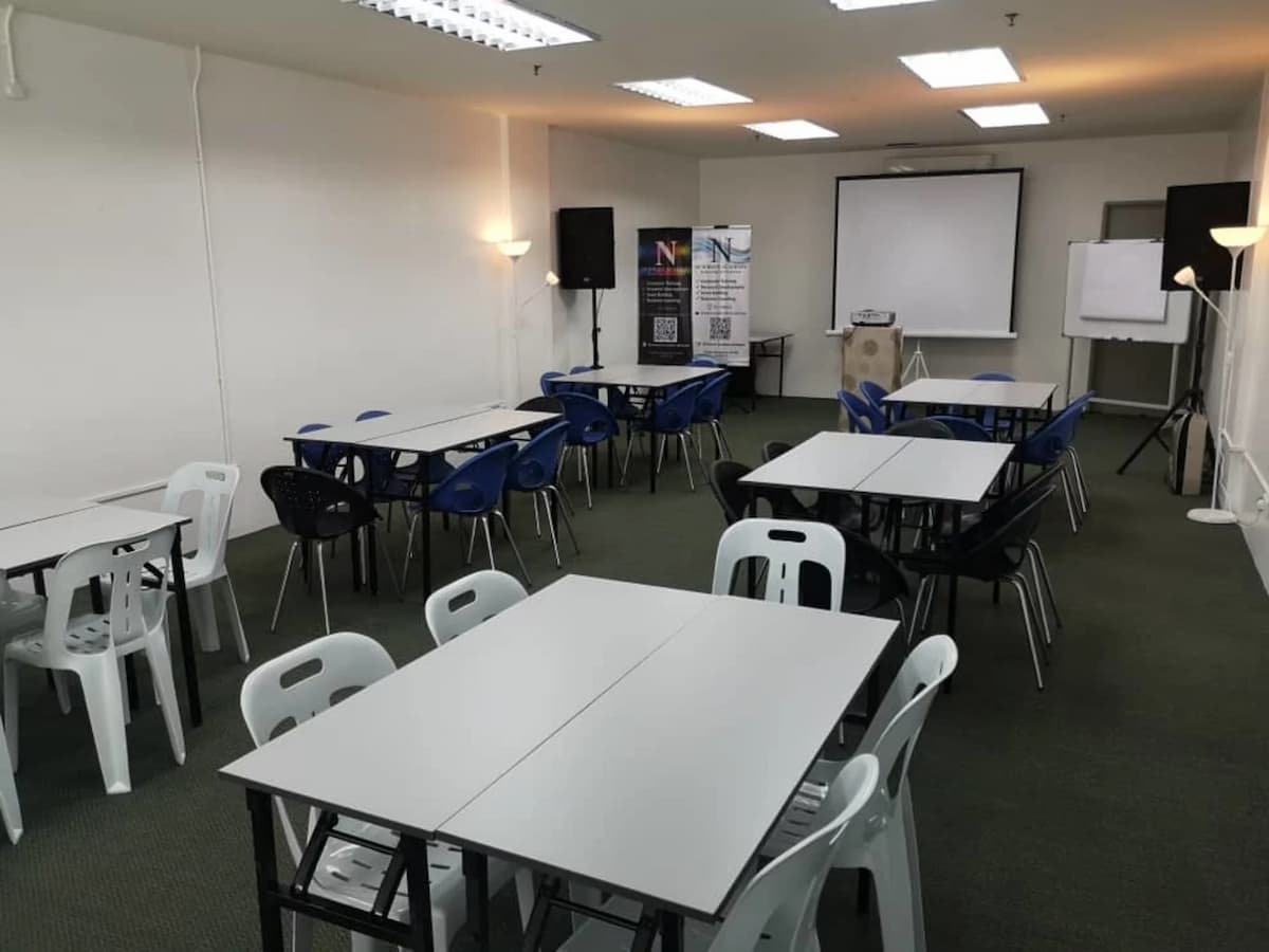 workshop event venue in penang with square table and projector screen