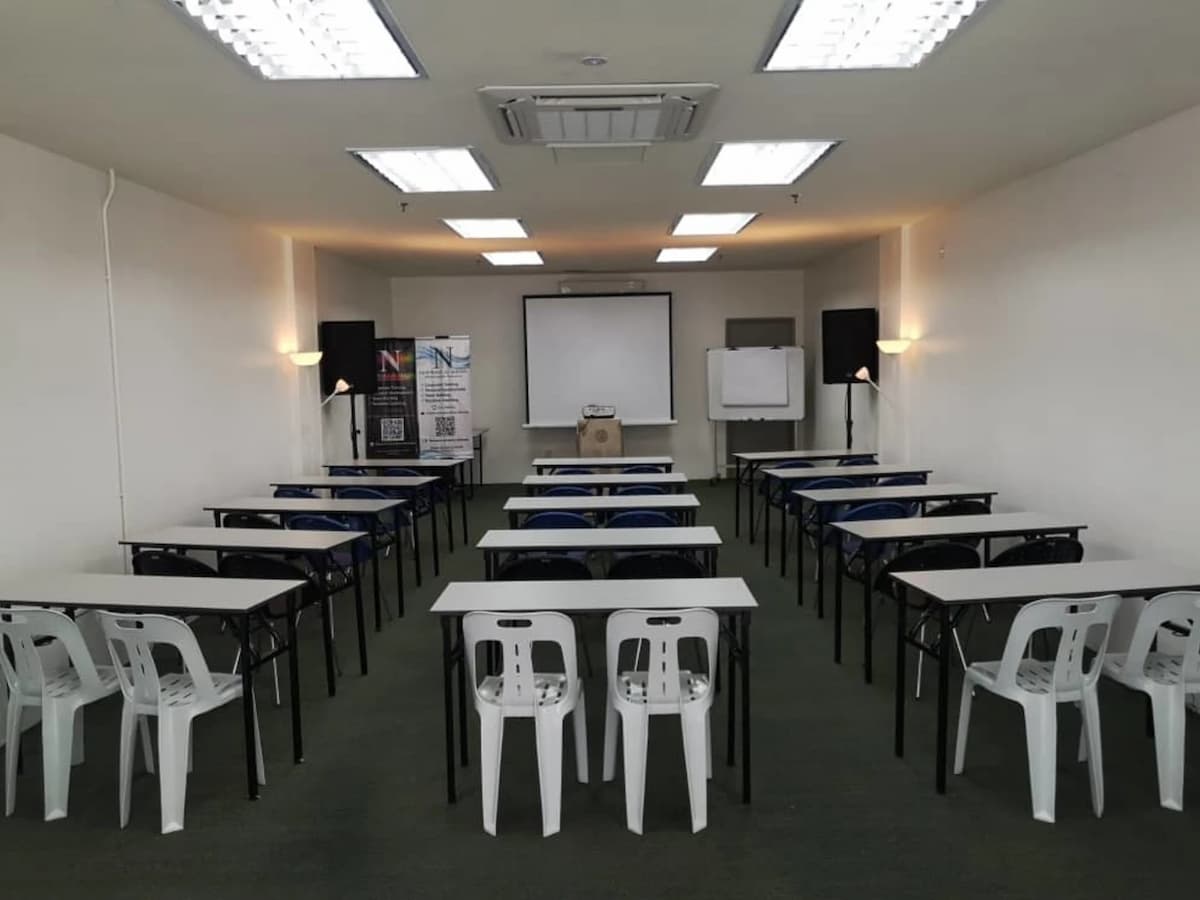 function room for seminar with projector screen and speakers