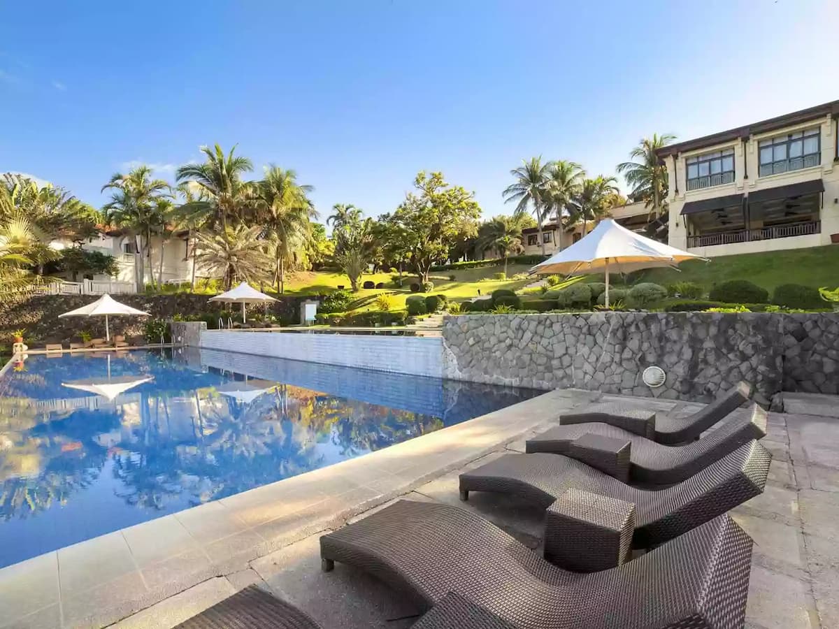 outdoor swimming pool area with green scenery view hotel batangas