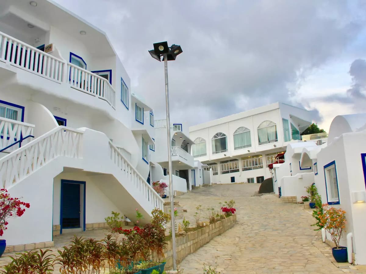 santorini style house in philippines with white theme and small plants surround hotel la union