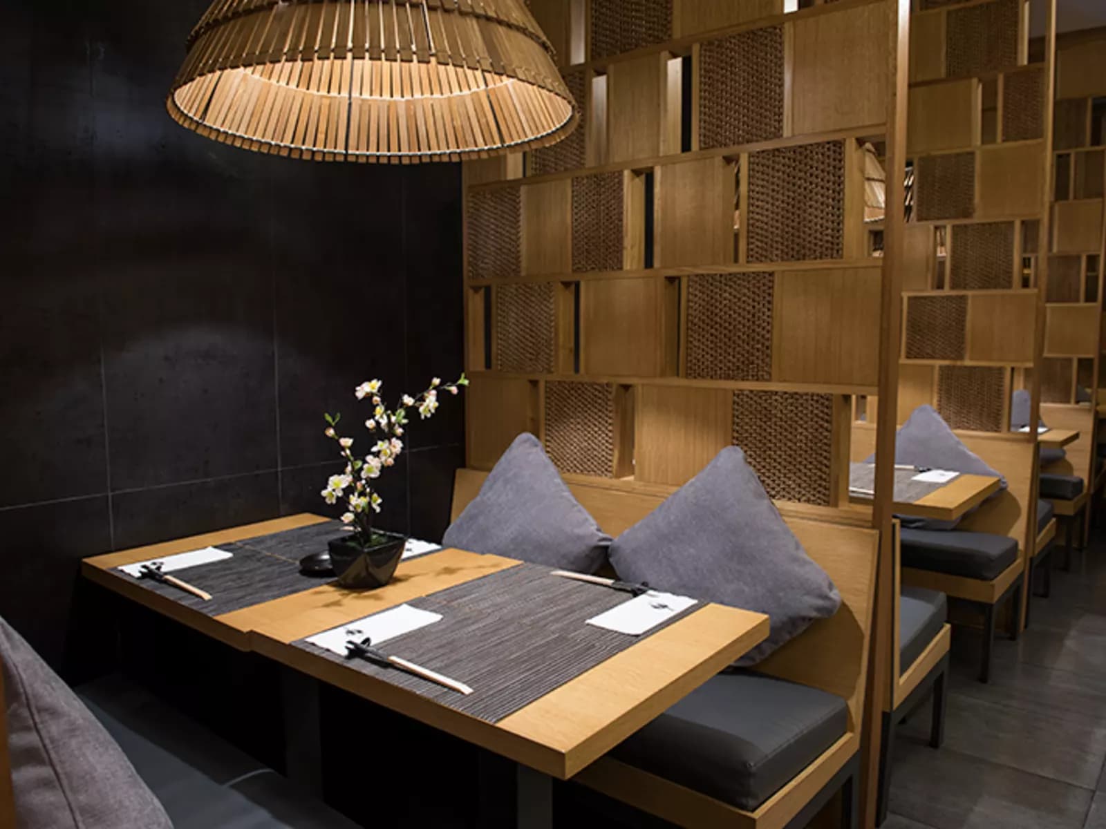 dining cubicles; wooden table and rattan decor restaurant pasig